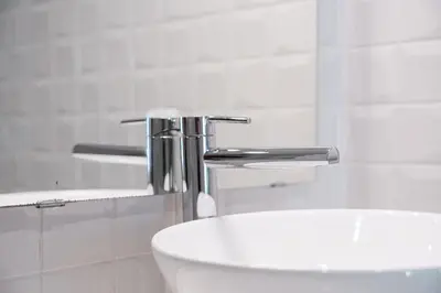 a white bathroom with a toilet and a sink at GuestReady - Modern Apartment in Bolhão in Porto