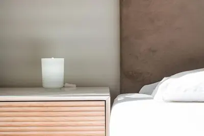 a bedroom with a bed with a candle on a dresser at GuestReady - Modern Apartment in Bolhão in Porto
