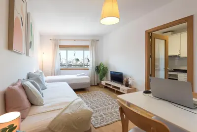 a dining room with a white table and chairs at Boavista Boho Apartment w/ Garage in Porto