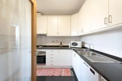 a bedroom with a large white bed with blue pillows at Boavista Boho Apartment w/ Garage in Porto