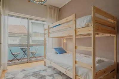 a bunk bed room with two bunk beds and a balcony at Sunny and Spacious House, 4BD 3Bath Downtown Porto in Porto