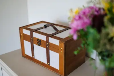 a box sitting on a table next to a vase of flowers at Sunny and Spacious House, 4BD 3Bath Downtown Porto in Porto
