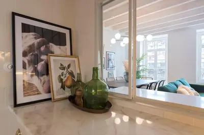 a living room with two green glass bottles on a counter at Mouzinho Luxury 3BR Flat l 5 min Walk to Ribeira by Lovelystay in Porto