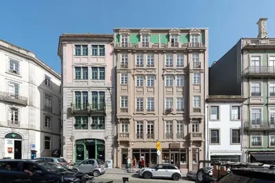 a group of buildings on a city street with cars at Mouzinho Luxury 3BR Flat l 5 min Walk to Ribeira by Lovelystay in Porto