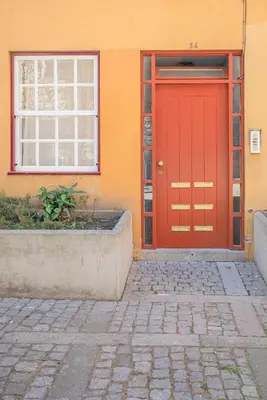 a red door on the side of a building at Liiiving in Porto - Ribeira Riverside Apartment in Porto