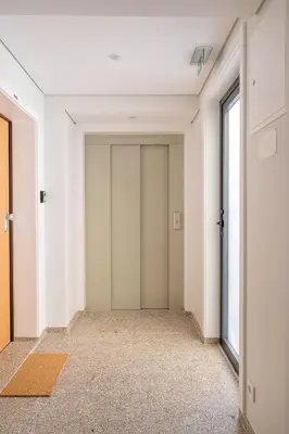 an empty hallway with white walls and doors at Strelitzia Apartment, by Bolhão Residences in Porto