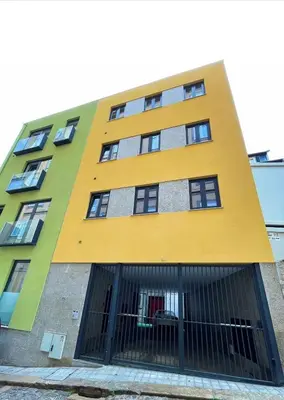 a yellow and green building with windows at Strelitzia Apartment, by Bolhão Residences in Porto