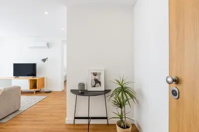 a living room with a table and a tv at Pestana Apartments - Premium in Porto