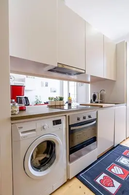 a kitchen with a washer and a washing machine at Porto Contemporary Apartment in city center in Porto