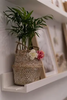 a vase with flowers sitting on a shelf at Porto Contemporary Apartment in city center in Porto