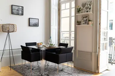 a dining room with a table and black chairs at Porto Contemporary Apartment in city center in Porto