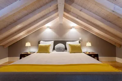 a bedroom with a large white bed with yellow pillows at Lemon Mezzanine - Santa Catarina in Porto