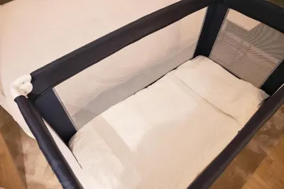 a small bed with a black and white bed frame at Palmeiras Apartment, by Bolhão Residences in Porto