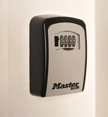 a master lock on a white wall at Palmeiras Apartment, by Bolhão Residences in Porto