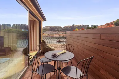 a table and chairs on a balcony with a view at 108MM House in Porto