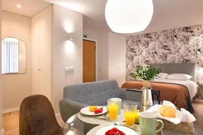 a room with a bed and a table with food on it at Nomad Apartment, by Bolhão Residences in Porto