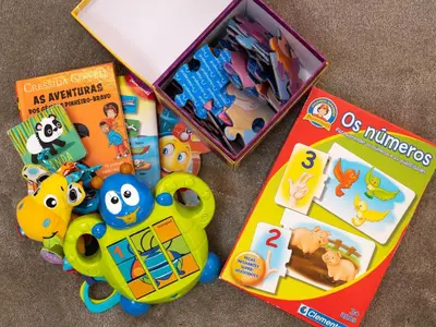 a childs toy set with a book and a box of toys at Nomad Apartment, by Bolhão Residences in Porto
