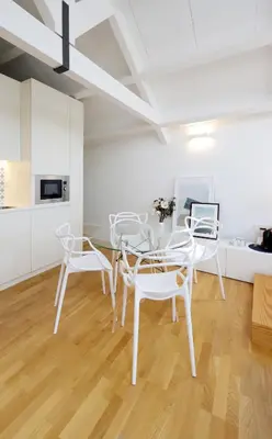 a dining room with white chairs and a table at Ribeira apartment 6M- vista fabulosa in Porto