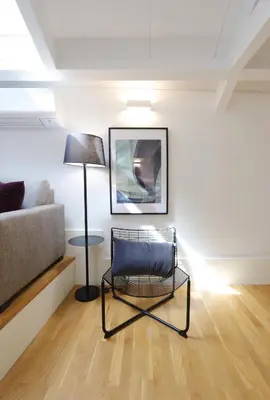 a living room with a chair and a couch at Ribeira apartment 6M- vista fabulosa in Porto