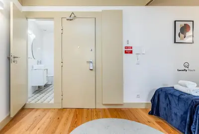 a bedroom with a door leading to a bathroom at Locally Yours Flores Apartments in Porto