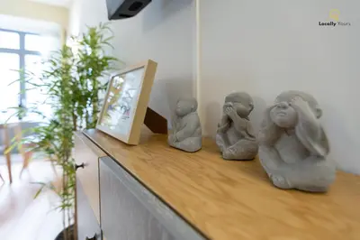 three little statues sitting on top of a counter at Locally Yours Flores Apartments in Porto