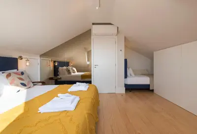 a bedroom with a large bed with yellow blanket at Porta do sol Luxury Apartment in Porto