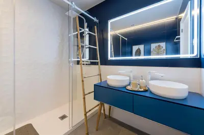 a bathroom with two sinks and a mirror at Porta do sol Luxury Apartment in Porto