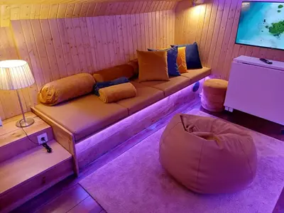 a living room with a couch and a ottoman at SLEEPBOAT LuxLife Yatch in Porto