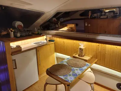 a small kitchen with a table and a table and chairs at SLEEPBOAT LuxLife Yatch in Porto