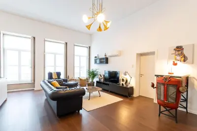 a living room with a couch and a tv at Porto - Your Avant-Garde Getaway in Porto