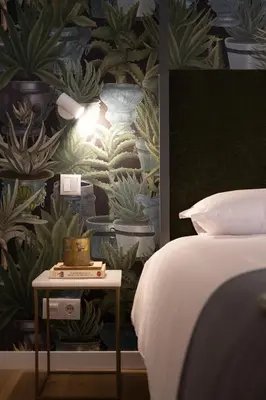 a bedroom with a bed and a wall with plants at Cactus Apartment, by Bolhão Residences in Porto
