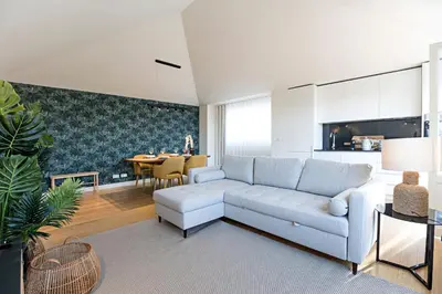 a living room with a white couch and a table at Aliados Premium 1BR w/ Terrace by LovelyStay in Porto