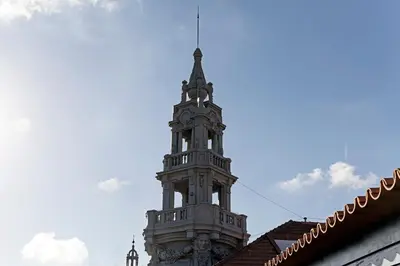 a tall clock tower on top of a building at Aliados Premium 1BR w/ Terrace by LovelyStay in Porto