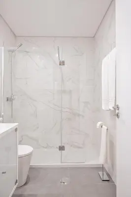 a white bathroom with a shower and a toilet at Savannah Apartment, by Bolhão Residences in Porto