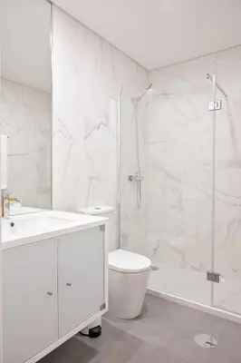 a white bathroom with a toilet and a shower at Savannah Apartment, by Bolhão Residences in Porto