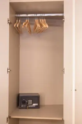 a walk in closet with a shelf with hangers at Savannah Apartment, by Bolhão Residences in Porto