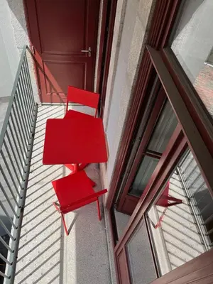 two red chairs sitting on a staircase next to a door at CASA SANTO ILDEFONSO in Porto