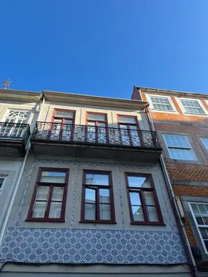a building with a balcony on the side of it at CASA SANTO ILDEFONSO in Porto