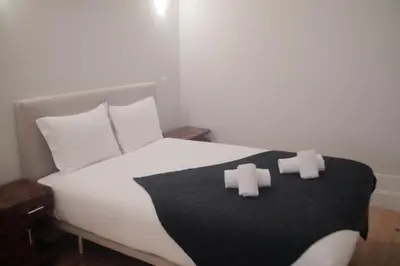 a bedroom with a bed with two crosses on it at CASA SANTO ILDEFONSO in Porto