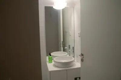 a bathroom with a sink and a large mirror at CASA SANTO ILDEFONSO in Porto