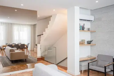 a living room with a staircase and a dining room at Liiiving in Porto - Design Bright House in Porto