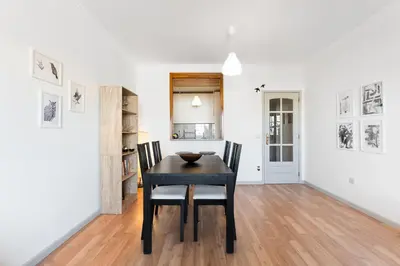 a dining room with a black table and chairs at Dream Views of Porto - Private Apt in Gaia by Lisbeyond in Vila Nova de Gaia