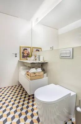 a bathroom with a white toilet and a checkered floor at Studio Duplex w/ AC In Praça República by LovelyStay in Porto