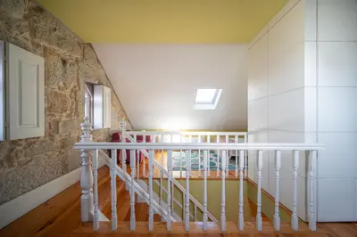 a staircase in a house with white railings at Near Boavista - Free Parking in Porto