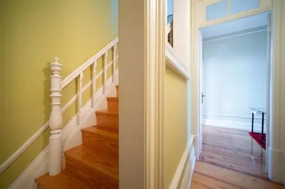 a hallway with a staircase and a door to a room at Near Boavista - Free Parking in Porto