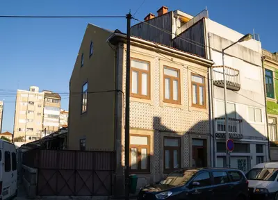 a building with a car parked in front of it at Near Boavista - Free Parking in Porto