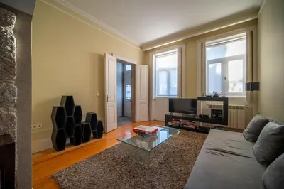 a living room with a couch and a tv at Near Boavista - Free Parking in Porto