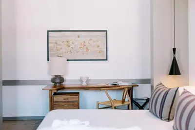 a bedroom with a bed and a desk with a lamp at The Editory Artist Baixa Porto Hotel in Porto