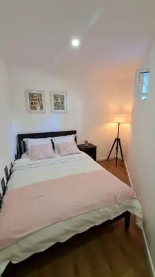 a bedroom with a large bed with a lamp at KirasHouse in Porto