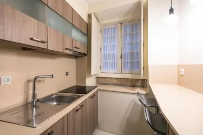 a kitchen with a sink and two chairs in it at Stay In Apartments in Porto